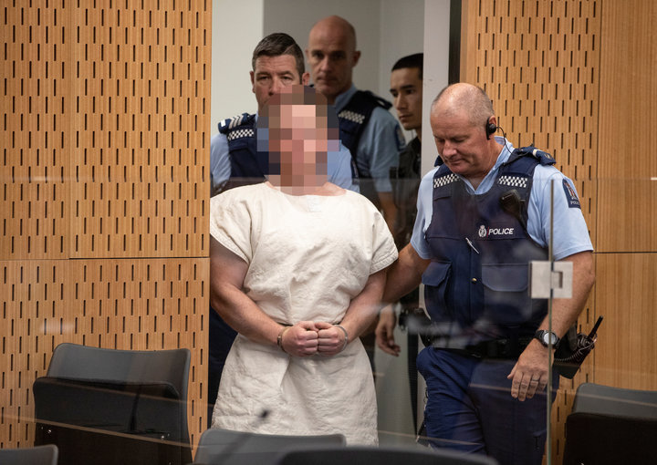 Brenton Tarrant, charged for murder in relation to the mosque attacks, is lead into the dock for his appearance in the Christchurch District Court